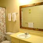 Framing A Bathroom Mirror with Pallets from Rachel Schultz